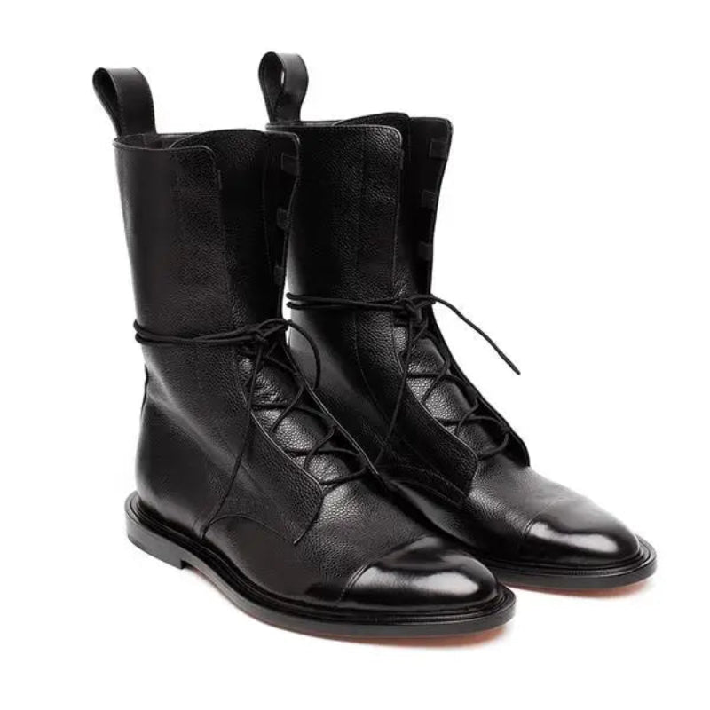 Pair of black leather boots with laces on a white background-side view