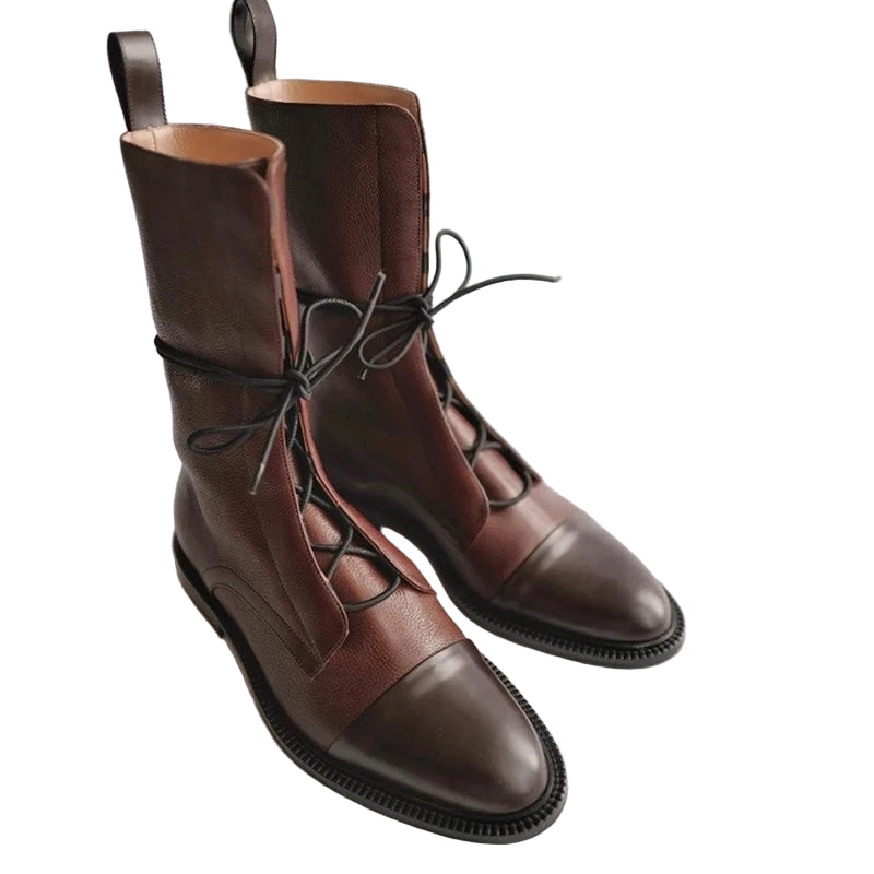 Pair of brown leather boots with black soles-side view